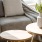 sunlight pours through a large window in furnished living room